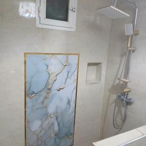 a bathroom with a shower with a glass door at Sultana in Ech Chorfa +22 photos