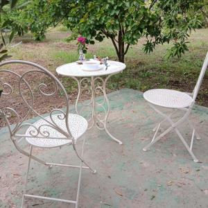 a table with two chairs and a table with flowers on it at Sultana in Ech Chorfa