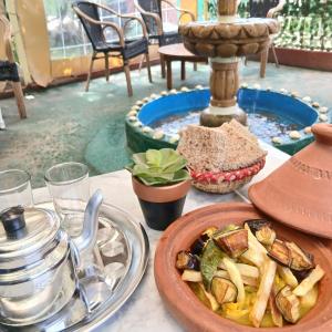 a table with a plate of food and a bowl of food at Sultana in Ech Chorfa