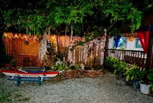 a boat sitting in a yard next to a fence at 3 J'S Homestay in Carles