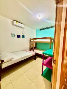 a room with two bunk beds and a table at Cabañas Turísticas Castrolandia in San Antero
