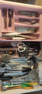 a pink container filled with lots of utensils at Apartament MaxMax in Los Abrigos