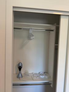 a closet with a door open with a sink at Downtown Escape in Surrey
