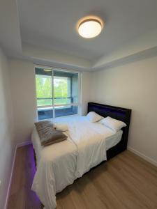 a bedroom with a large bed and a window at Downtown Escape in Surrey