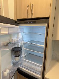an empty refrigerator with its door open in a kitchen at Downtown Escape in Surrey +11 photos