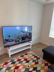 a living room with a large fish tank on a tv at Downtown Escape in Surrey