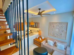 a living room with a couch and a bath tub at Baliris Home Boutique Legian in Seminyak +102 photos