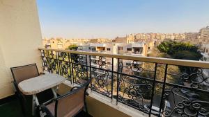a balcony with a chair and a view of a city at Temple host in Cairo