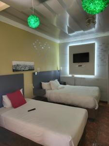 a hotel room with two beds and a flat screen tv at THK Properties in Pretoria +48 photos