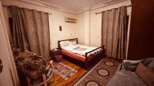 a small room with a bed and a couch at Temple host in Cairo