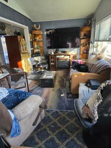 a living room with couches and a flat screen tv at Lillian's Cozy Corner in Palmer