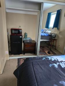 a reflection of a bedroom with a bed and a mirror at Lillian's Cozy Corner in Palmer
