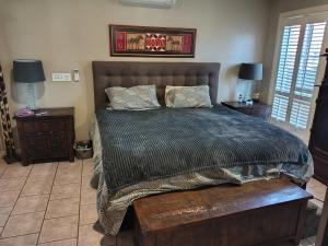 a bedroom with a large bed and two night stands at 1 bed room dog friendly accommodation in Tarneit