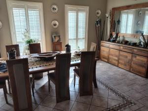 a dining room with a wooden table and chairs at 1 bed room dog friendly accommodation in Tarneit +14 photos