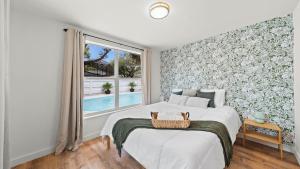 a bedroom with a large bed and a window at The Oasis - 2 Private Homes, Pool, and BBQ in New Port Richey