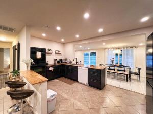 a large kitchen with a sink and a counter at The Oasis - 2 Private Homes, Pool, and BBQ in New Port Richey