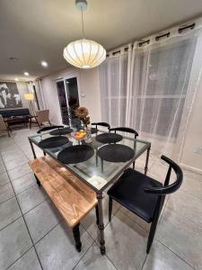 a dining room with a glass table and chairs at The Oasis - 2 Private Homes, Pool, and BBQ in New Port Richey