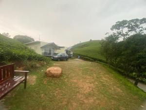 a car parked in a yard next to a house at Misty Glen in Vagamon