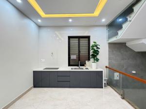 a kitchen with a sink in a room at Pi Home in Dong Hoi