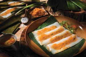 two pieces of fish on a plate on a table at Pi Home in Dong Hoi