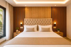 a bedroom with a large bed with a large headboard at Madani Palazza Appart & Duplex in Marrakesh