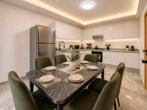 a kitchen and dining room with a table and chairs at Madani Palazza Appart & Duplex in Marrakesh