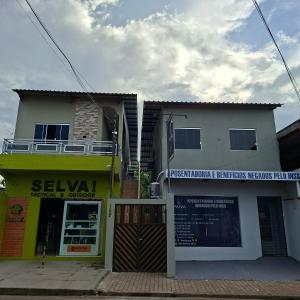a building with a sign in front of a store at Apartamento Selva in Itaquatiara