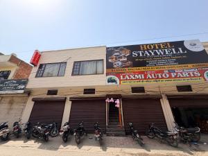 a bunch of motorcycles parked in front of a building at Hotel Staywell in Karnal