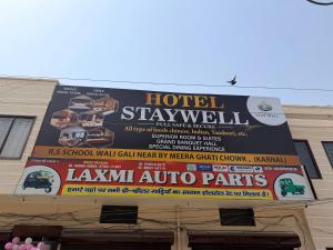 a large billboard on the side of a building at Hotel Staywell in Karnal