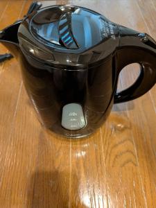 a black coffee pot sitting on a wooden table at 大濠ウエストヴィレッジ409 in Fukuoka
