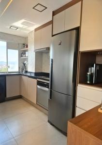 a kitchen with a stainless steel refrigerator at APTO 42M l 7 km Alphaville in Osasco