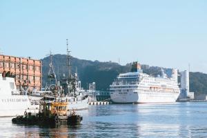 a cruise ship docked in a harbor with boats at Drizzle Inn in Keelung