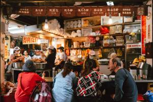 a group of people ordering food in a restaurant at Drizzle Inn in Keelung