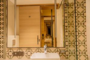 a bathroom with a sink and a mirror at Hotel Prince Residency, Bhuj in Bhuj +22 photos