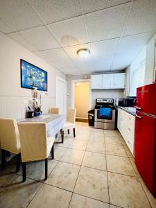 a kitchen with a table and chairs and a red refrigerator at Niagara View at LaSalle SH in Niagara Falls