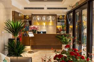 a store with flowers and plants in front of a counter at Aroma Hotel An Khánh in Vân Lũng