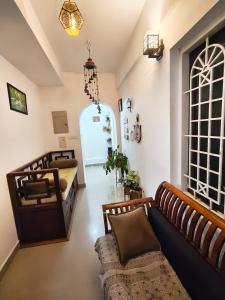 a living room with two beds and a couch at Sky Loft in Trivandrum