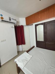 a small bedroom with a bed and a window at Sky Loft in Trivandrum