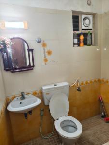 a bathroom with a toilet and a sink at Sky Loft in Trivandrum