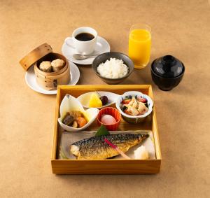 a tray of food with a box of fish and a cup of coffee at PROSTYLE Ryokan Yokohama Bashamichi in Yokohama
