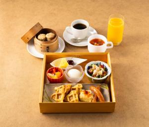 a lunch box with food and a cup of coffee at PROSTYLE Ryokan Yokohama Bashamichi in Yokohama
