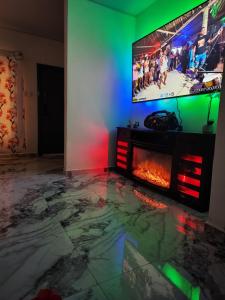 a living room with a fireplace and a flat screen tv at Casa Lujosa in Choluteca