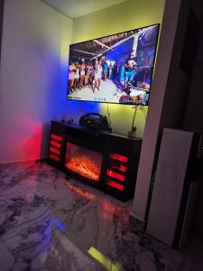 a living room with a tv and a fireplace at Casa Lujosa in Choluteca +2 photos