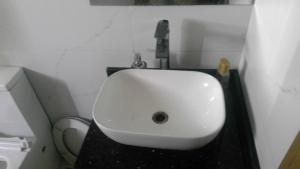 a white sink in a bathroom with a toilet at wowspa in Ajman 