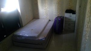 a small bed in a corner of a room at wowspa in Ajman 