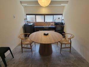 a table in a room with chairs and a sink at Rinku Base Ichi in Tajiri