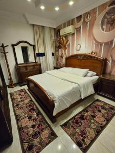 a bedroom with a large bed and a rug at Villas with direct sea views and apartments with partial sea views in Miami, Alexandria, Al Safwa Tower, in Alexandria