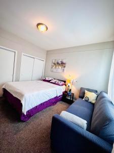 a bedroom with two beds and a couch at Niagara View at LaSalle SH in Niagara Falls