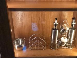 a shelf with bottles and utensils on it at RoofTop8 in Cochabamba