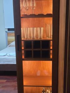 a cupboard filled with wine glasses on top of it at RoofTop8 in Cochabamba +8 photos